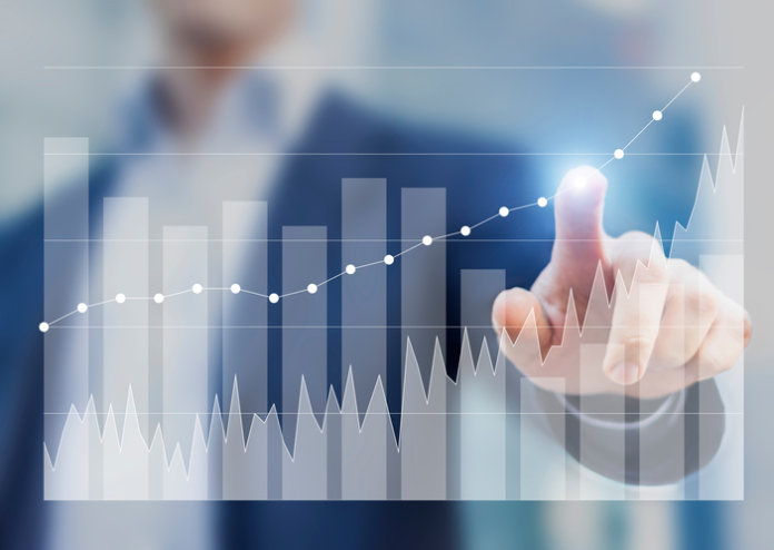 Expert businessman using business intelligence to sketch future growth and success with charts